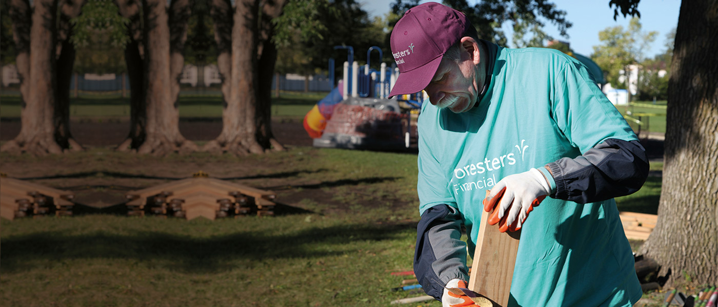 Foresters president helping at a Foresters community event doing building work