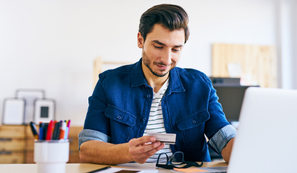 Man on laptop being cautious entering credit card details online