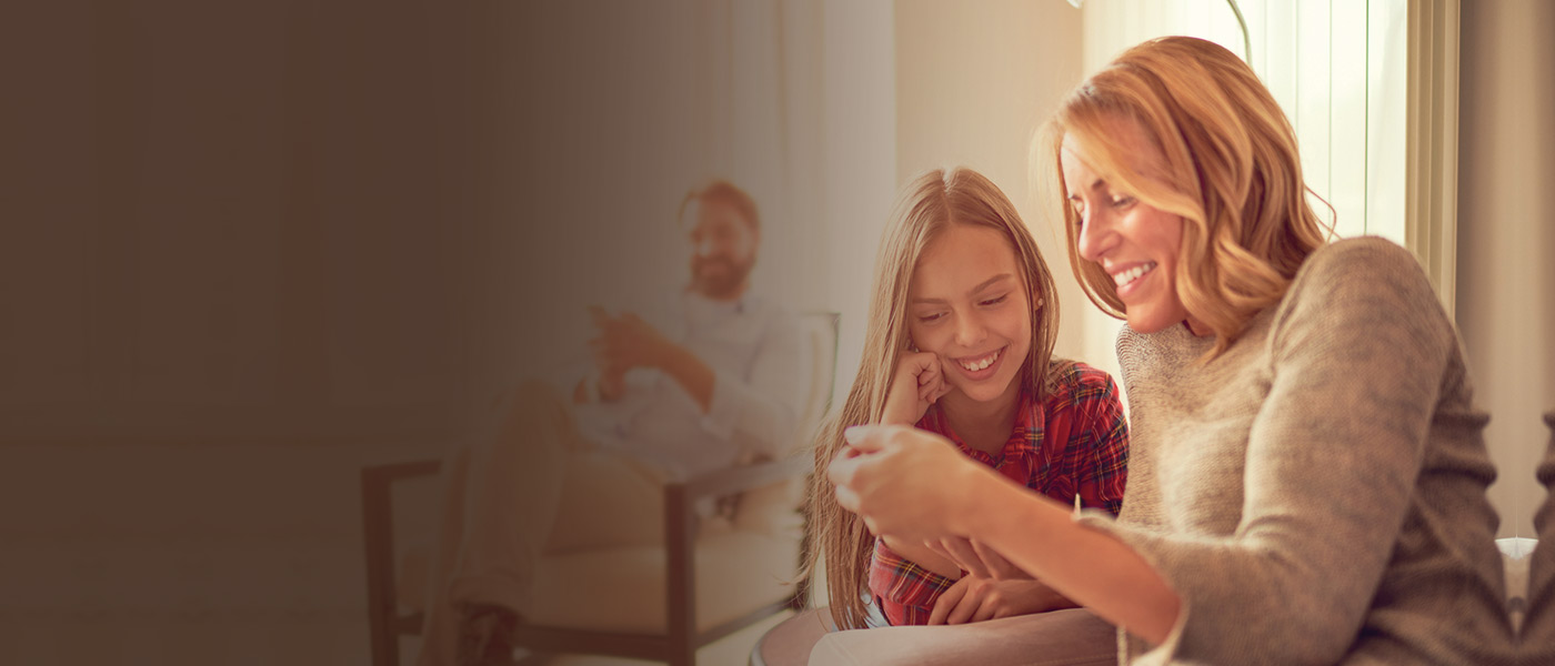 Happy mother and daughter working out the CTF Plan value using Foresters calculator
