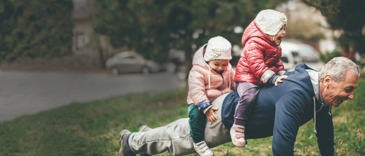 Happy granddad playing with his grandchildren after working out their Plan values