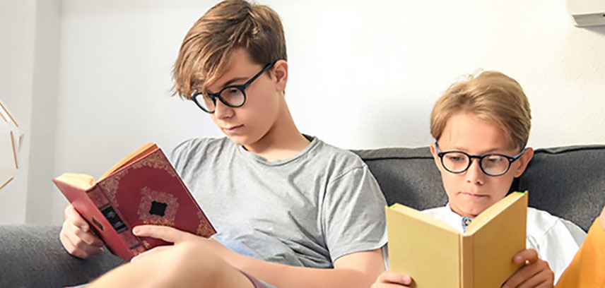 Two boys reading books